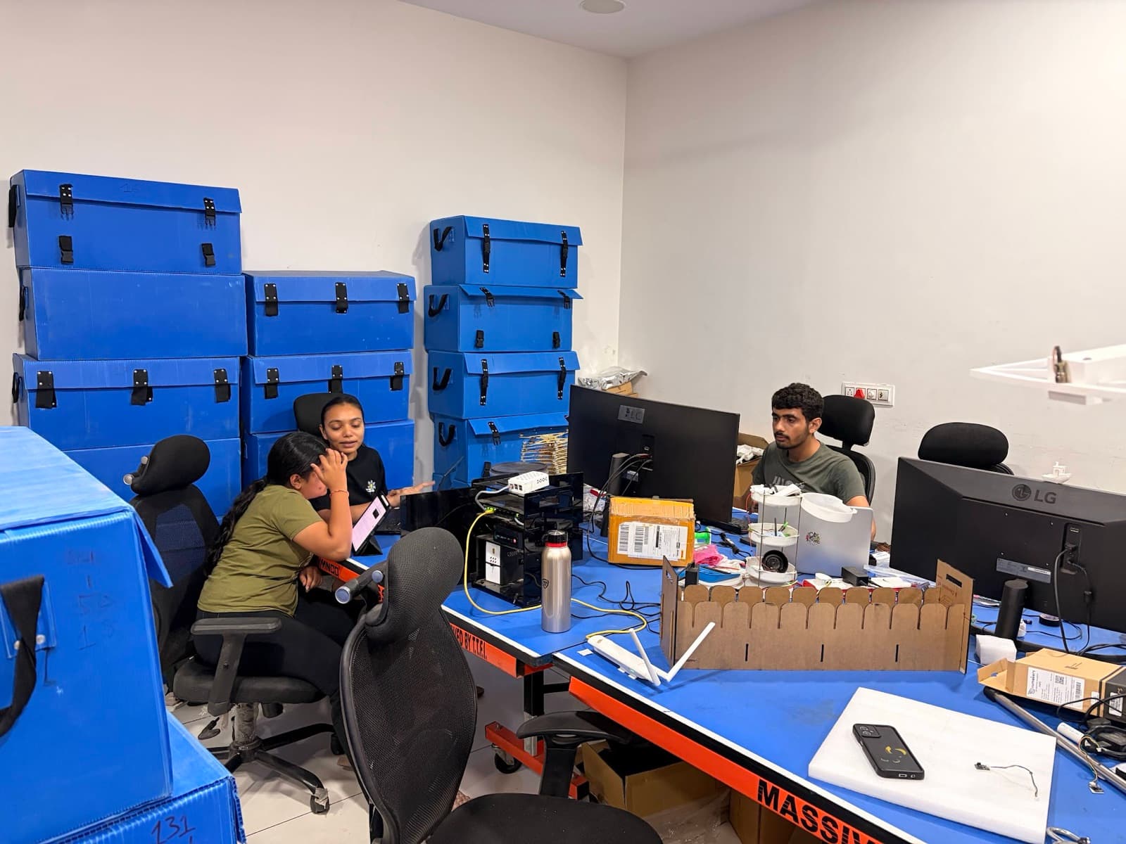 Airoveda technical team working beside blue drone flight cases for the 180-drone Tiranga Concert Gandhinagar show